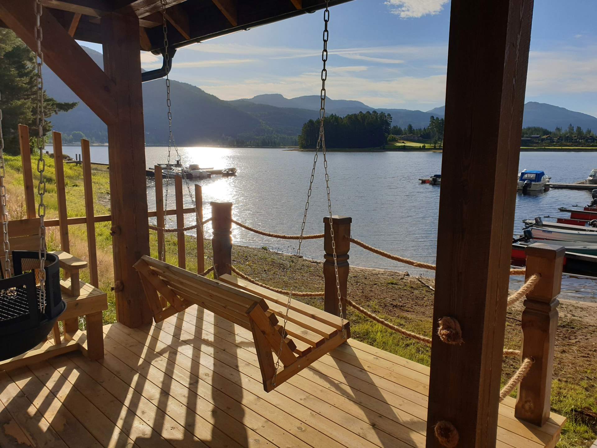 Lakeside swing on a wooden terrace